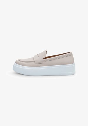 Light beige slip-on shoes with a mock toe, a padded upper, and a thick white sole. Smooth texture with minimalistic design and subtle detailing.