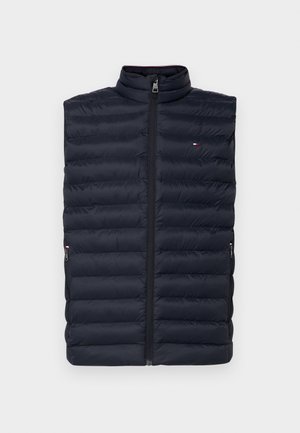 Navy blue puffer vest with horizontal quilted design, high collar, and front zip. Features two zippered side pockets.