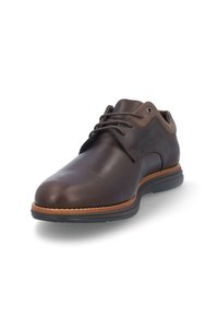Zapato de cuero marrón con puntera redondeada, diseño con cordones, suela en contraste y detalles de costura sutiles. Acabado suave con una textura mate.