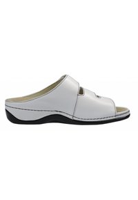 White leather clogs with an open toe, featuring two cut-out sections. Black rubber sole with contrast stitching along the edges.