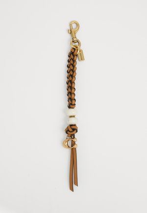 Braided leather keychain in brown and tan, featuring a glossy white bead, gold hardware, and a lobster clasp with branding tag.