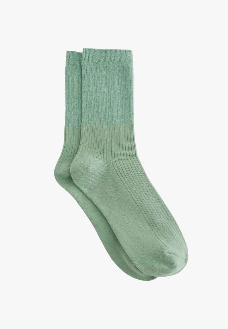 Light green ribbed socks made of soft material with a smooth texture and a medium height design. Features a solid color without patterns.