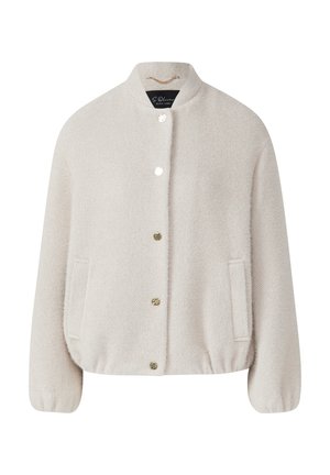 Veste beige clair en tissu texturé, avec un col arrondi, une fermeture à boutons et deux poches latérales. Détails en matériel doré.