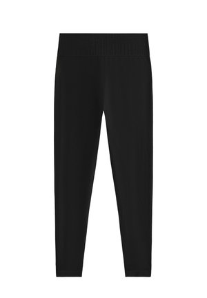 Leggings noirs en tissu extensible. Ils possèdent une large taille côtelée et une silhouette ajustée qui s'affine aux chevilles.