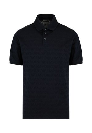 Polo shirt bleu marine en tissu texturé, présentant un motif de logo en relief subtil. Il a un col classique et une patte de boutonnage à trois boutons.