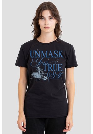 Young woman wearing a black t-shirt with blue text "UNMASK Your TRUE Self" and illustrations of a mask and perfume bottle on front.