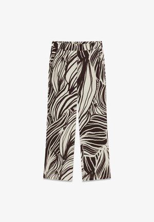 Pantalones de pierna ancha con cintura alta, con un patrón abstracto de hojas en blanco y negro sobre un fondo claro.