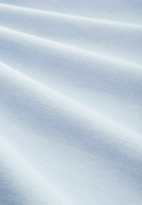 Tessuto azzurro chiaro con una consistenza morbida e liscia, che presenta pieghe delicate e una leggera lucentezza. Il materiale ha un motivo di tessitura uniforme.