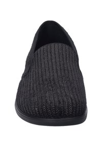 Black slip-on shoe featuring a textured, ribbed fabric upper with a woven pattern, rounded toe, and a solid black rubber sole.