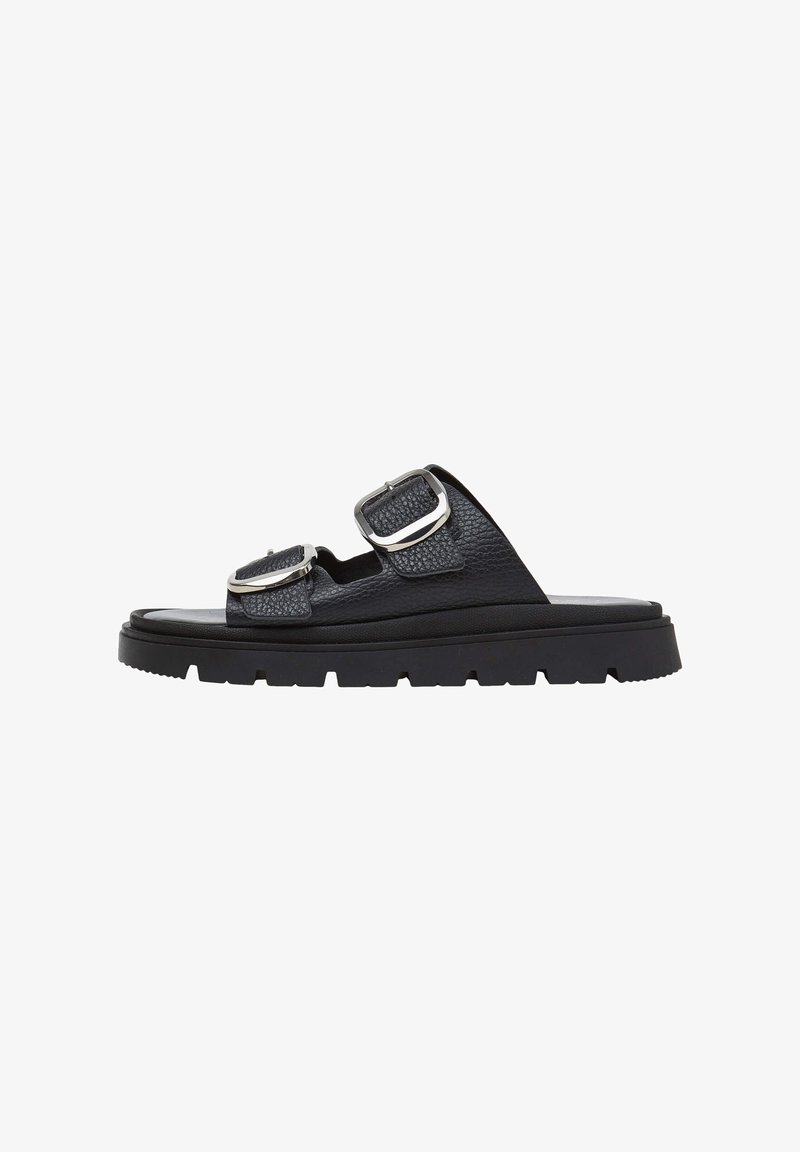 Black leather slide sandal with thick rubber sole and two adjustable silver buckles across the top.