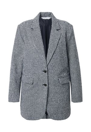 Houndstooth bleiseri mustassa ja valkoisessa, jossa on klassinen muotoilu, lovet kauluksessa, kaksi etutaskua ja kaksi nappia. Pehmeä rakenne.