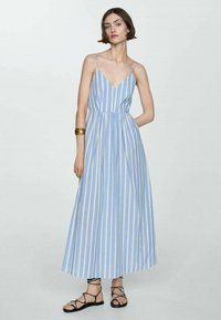 Blue and white striped maxi dress with a V-neckline, thin straps, and gathered waist. Features a flowy silhouette and lightweight fabric.