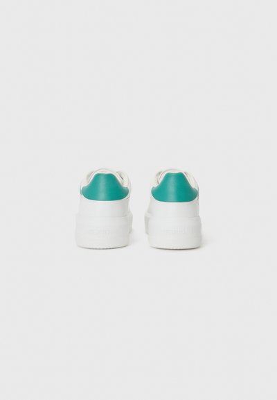 White sneakers with a teal accent at the heel, featuring a rounded shape and chunky white sole. Smooth texture with branding on the back.