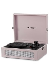 Crosley turntable in pale pink with a black platter, adjustable tonearm, and a front speaker grille featuring a grid pattern.
