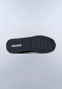 Black sneaker sole with a textured rubber pattern, featuring a logo plate and a rounded toe. The tread is patterned for grip and traction.