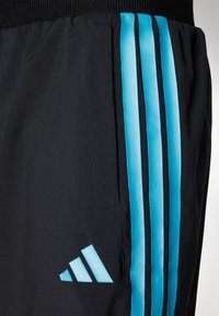 Black athletic shorts featuring three vertical blue stripes and an adidas logo in light blue on the lower left side. Smooth fabric texture.