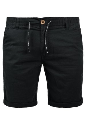 Zwarte katoenen shorts met een elastische tailleband, trekkoord en opgerolde boorden. Heeft zijzakken en een houten knoopdetail.