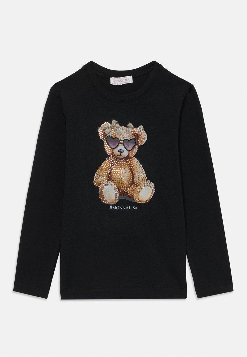 Ilgi piedurkņu melns krekls ar teddy bear grafiku, kas rotāta ar rhinestones, valkājot violetus saulesbrilles un loku. Zem tā ir uzraksts "#MONNALISA".