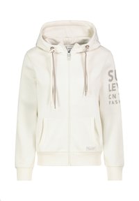 Helle beige Zip-Hoodie mit geräumiger Kapuze, beigen Kordeln, Vordertaschen und dem Aufdruck "SULY LEVEL" in Grau auf dem linken Ärmel.