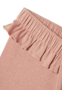 Ljusrosa leggings med en mjuk textur, med en volangmidja och samlad elastik. Enkelt design utan ytterligare mönster.