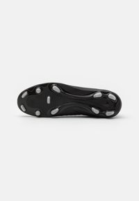 Suola di scarpa sportiva nera con una texture liscia, caratterizzata da sei tacchetti in gomma trasparente e un design ondulato unico per una migliore aderenza.
