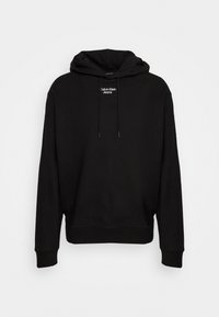 Felpa nera in cotone con cappuccio e lacci, polsini e fondo a costine, con un piccolo logo bianco "Calvin Klein Jeans" sul davanti.