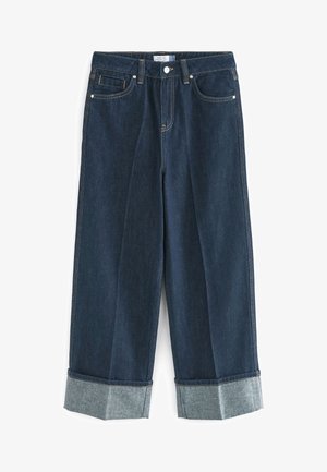 Dżinsy z szerokimi nogawkami w ciemnoniebieskim kolorze z mankietami u dołu, zapinane z przodu na guziki i zamek oraz z klasycznym wzorem z pięcioma kieszeniami.