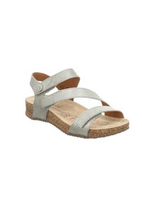 Metallisch silberne Sandalen mit überkreuzten Riemen, Korksohle und einer strukturierten Oberfläche. Offene Zehenpartie mit einer markierten Innensohle.