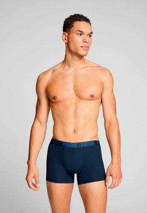 Men's dark blue boxer briefs made of soft fabric, featuring a branded elastic waistband with “PUMA” in contrasting blue.