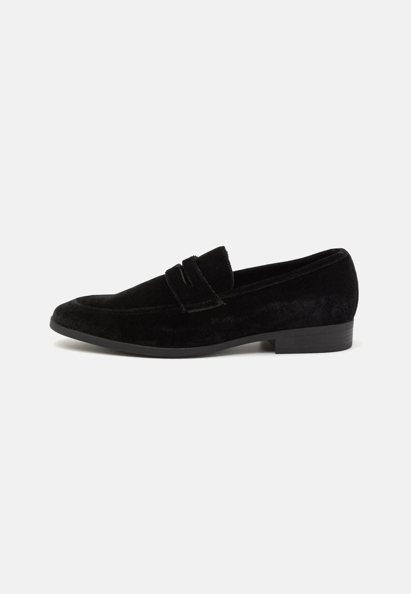Black suede loafers with a flat heel and vamp accent. Features smooth texture and classic design. Suitable for formal or casual wear.