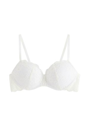 Reggiseno bianco in pizzo con motivi floreali, coppe con ferretto, spalline regolabili e bordi ondulati.