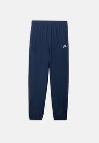 Námornícke tepláky so sťahovacím pásom a manžetami. Na ľavom stehne je umiestnené malé biele logo Nike. Hladká a ľahká látka.