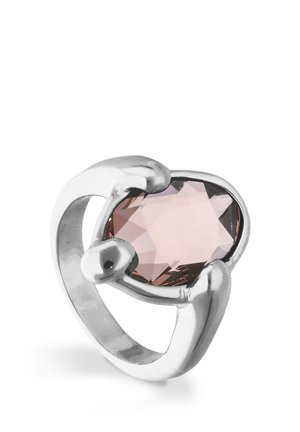 Anillo de plata con una piedra preciosa rosa ovalada y facetada, sujeta por tres garras en un diseño moderno de banda abierta.
