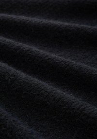 Black wool fabric with a soft, textured surface, featuring subtle horizontal lines and a slightly fuzzy appearance.