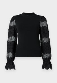 Maglione nero con corpo aderente. Maniche a sbuffo in pizzo trasparente con motivi floreali e design a quadretti. Colletto e polsini a coste.