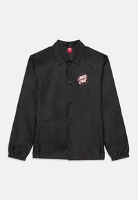 Svart vindjacka med knäppning, raglanärmar, elastiska ärmslut och en röd cirkulär logotyp med texten "SANTA CRUZ" på bröstet.