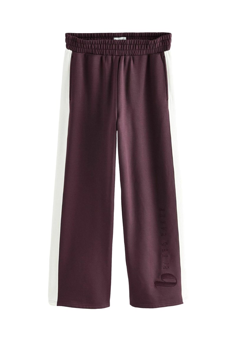 Pantaloni ampi bordeaux con pannelli laterali bianchi, vita elastica e dettaglio del logo in rilievo sulla gamba sinistra. Tessuto liscio e morbido.
