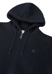 Felpa con cappuccio e zip in tessuto blu scuro. Caratterizzata da una zip a lunghezza totale, cordini e una piccola etichetta con logo sul petto. Texture morbida.