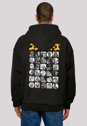 Black hoodie featuring a large graphic print on the back with various monochrome character illustrations and yellow text above.