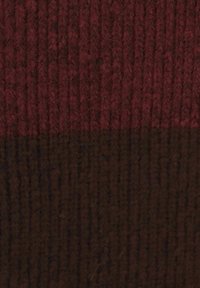 Knitted fabric featuring a two-tone design, with a top maroon section and a brown bottom section, showcasing a textured rib pattern.