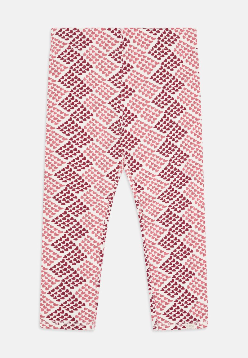 Leggings en tissu doux avec un fond blanc comportant un motif diagonal de cœurs rouges et roses de tailles variées.