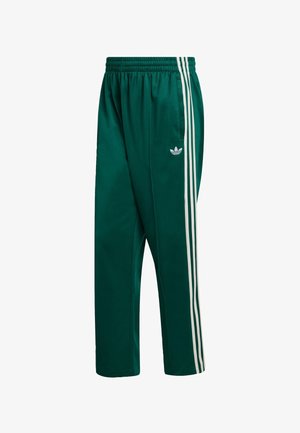 Green athletic pants made of smooth fabric with an elastic waistband, featuring three white stripes along the sides and an embroidered logo.