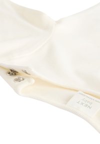 Cotton baby bodysuit in cream color, featuring a rounded neckline, snap closures on the side, and a branded tag with "NEXT Baby."