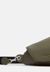 Oliwkowa skórzana torba na ramię z zapinaną klapą, wyposażona w srebrny klips oraz czarny regulowany pasek. Gładka tekstura.