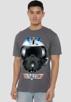 Gray t-shirt featuring a graphic of an aviator helmet with blue accents and the "TOP GUN" logo in red beneath the helmet design.