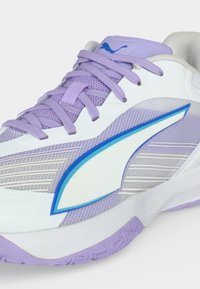 Άσπρο και λεβαντί αθλητικό παπούτσι Puma με επάνω μέρος από δίχτυ, παχιά σόλα, λογότυπο Puma με μπλε ακτίνες και κορδόνια λεβαντί.