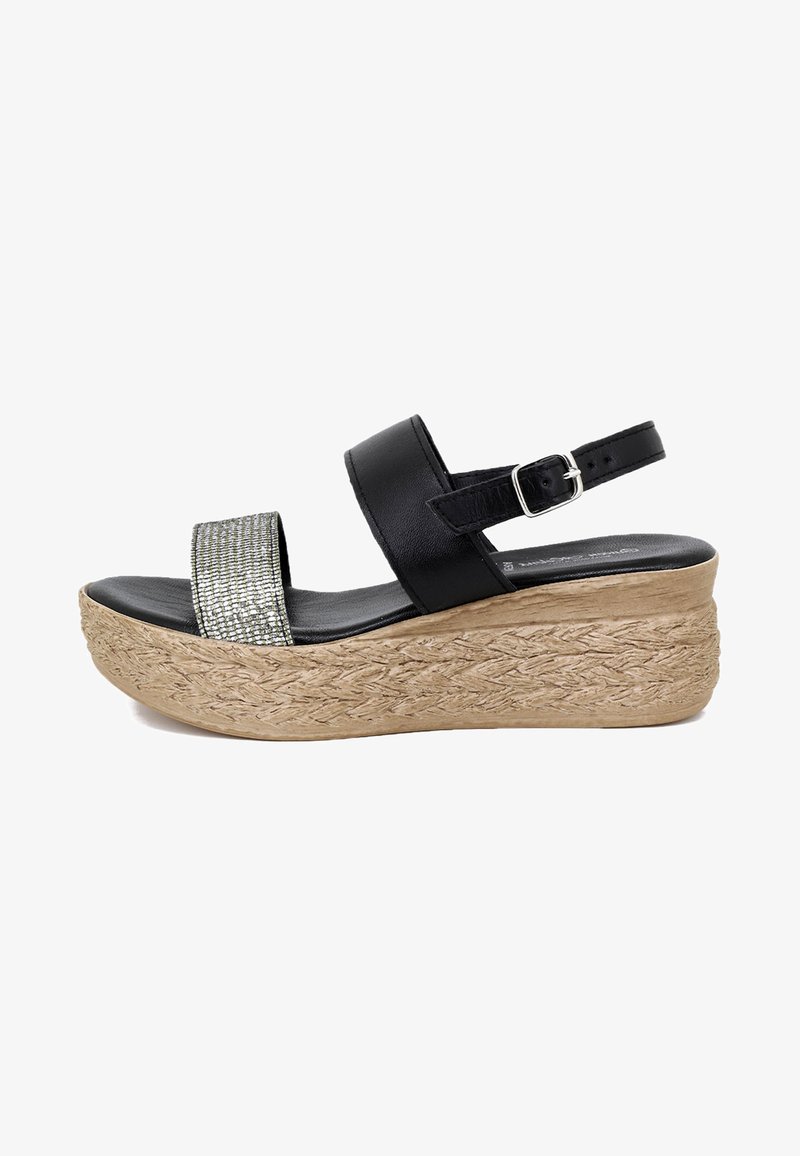 Sandali wedges neri con una fascia larga e texturizzata in glitter e una cinghia alla caviglia regolabile. La base rivestita in juta aggiunge una texture naturale.