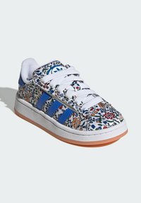 White sneakers with colorful floral pattern, blue stripes, and classic lace-up design. Rubber sole and padded collar for comfort.