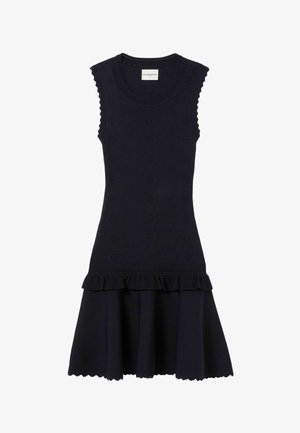 Vestido negro sin mangas con patrones florales de ojales, bordes ondulados, volantes en la cintura caída y cuello redondo.