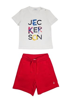 Camicia bianca a maniche corte con scritta colorata "JECKERSON" sopra pantaloncini rossi con coulisse, tasche anteriori e piccolo logo bianco sulla gamba.